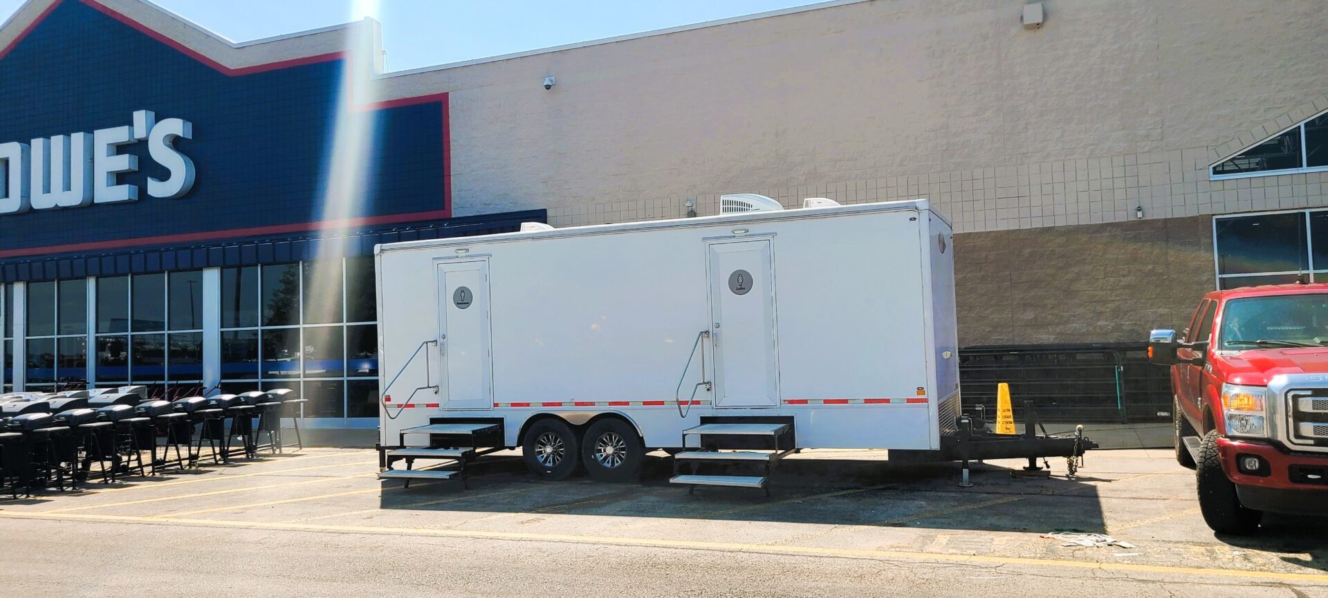portable bathroom trailer outside of Lowe's