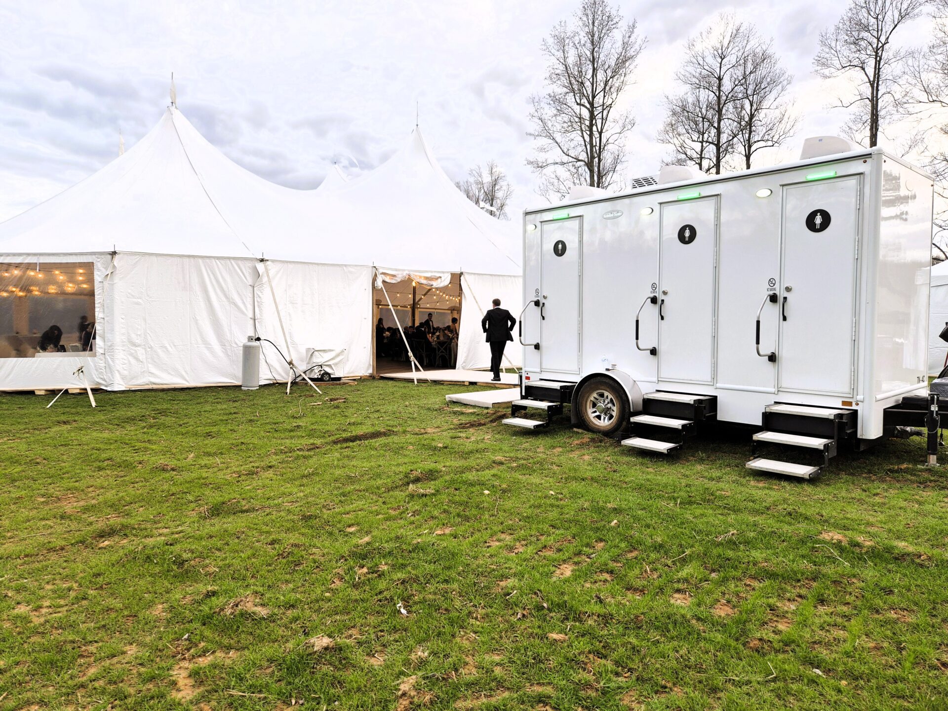luxury portable bathroom outside of wedding tent